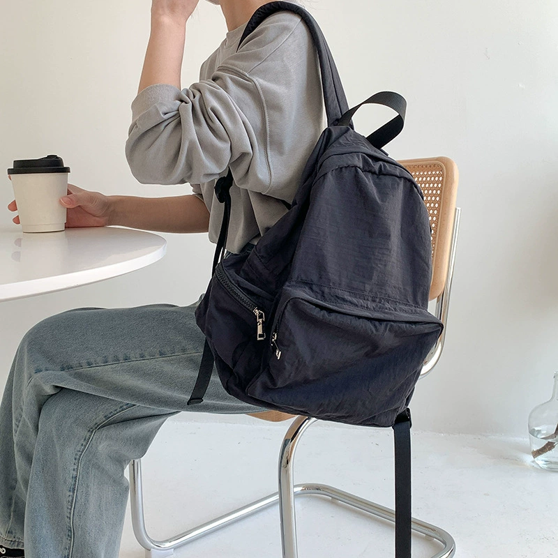 2025 Sac à dos de style coréen sac à dos de grande capacité Sac en tissu collégial Sackepack Couleur solide simple sac à école en nylon simple