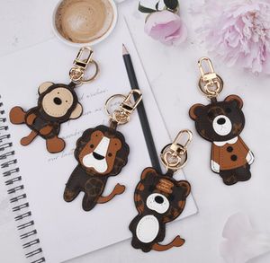 Diseñador de moda dibujos animados animal llavero anillos clásico unisex de alta calidad llavero de cuero genuino accesorios lujo flor patrón coche mochila llaveros joyas