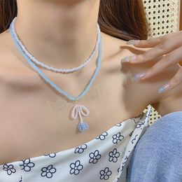 Collier Double couche de perles de cristal faites à la main, pendentif fleur avec nœud papillon, bijoux de fête pour femmes