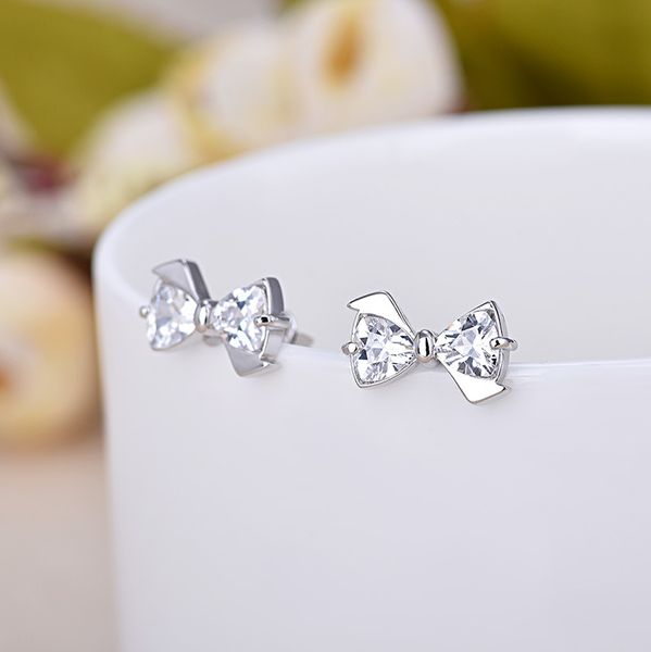 Pendientes de tuerca para mujer a la moda, bonitos pendientes de tuerca de cristal brillante plateado con lazo, pendientes de diamante de diseñador