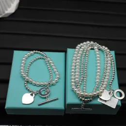Collier de luxe de mode bijoux de créateur coeur retour au pendentif chaînes à double pont en forme de coeur avec colliers de perles bracelet S925 pour boîte à bijoux en platine de fête