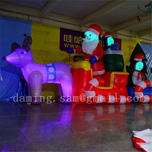 Trineo inflable gigante de precio más barato de China con pingüino y Papá Noel para decoración navideña del parque de la ciudad