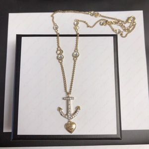 Collier de couple en forme de coeur de gouvernail en or, bijoux cadeaux, collier de créateur pour hommes et femmes.