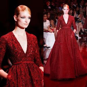 Precioso Elie Saab Rojo Noble Vestidos de noche Vestidos famosos Lentejuelas Brillante Escote en V profundo Longitud del piso Manga larga Pista Formal287h