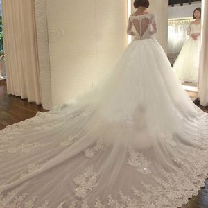 Prachtige illusie lange mouw trouwjurk ronde hals kralen kant applicaties pure hartvormige rug jurk met lange trein bruids 2195