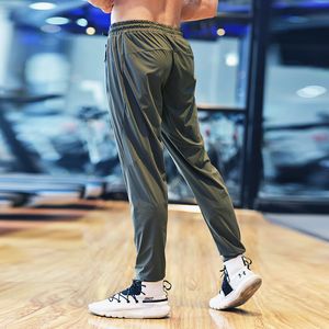 Pantalon de survêtement d'entraînement mince vert ajustement séchage rapide confortable Joggers hommes course pantalons longs Gym Sports Fitness pantalon poche zippée