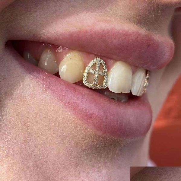 Grillz, parrillas dentales rachelz hip hop hop hueco circón dientes cruzados Grillz 14k dorado Cz Cabas de muelas de piedra Decoración para mujeres Jewelr Dhe9r