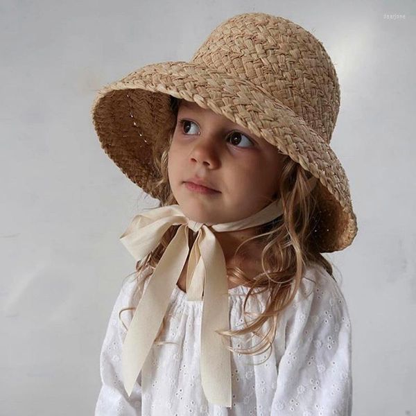 Venta al por mayor de sombreros para niñas, sol de rafia de verano con cinta larga, sombrero de playa plano para niños, cubo de paja UV para niños, accesorios de Panamá