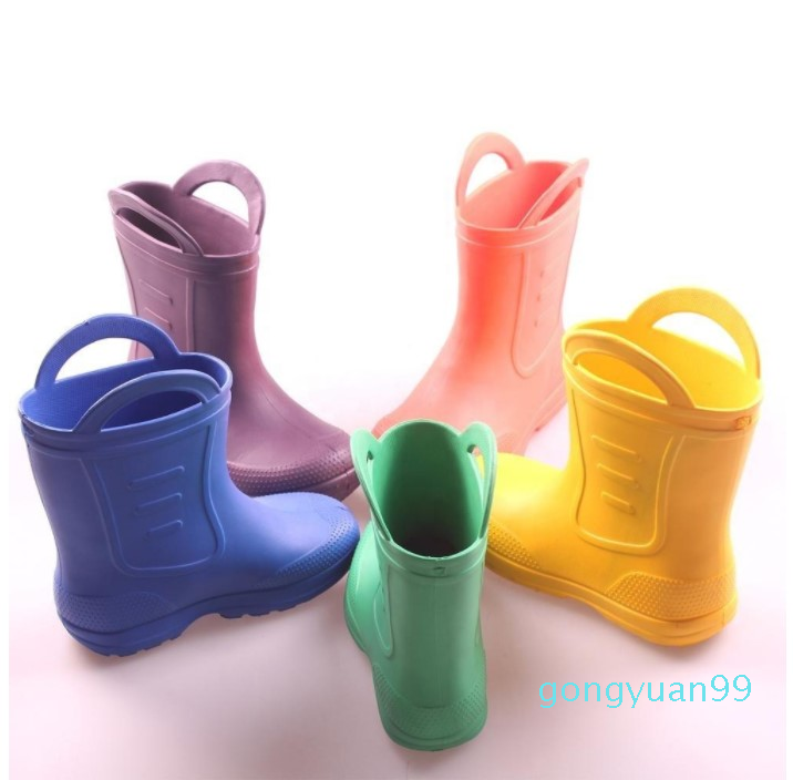 Venta al por mayor de EVA para niños de color puro impermeable de alta calidad y barato, botas de lluvia para niños chanclos