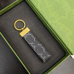 Porte-clés en cuir de haute qualité classique exquis designer voiture porte-clés en alliage de zinc lettre unisexe lanière or noir métal petits bijoux GG2023