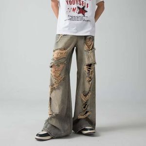 High Street Wasteland coloré un jean en détresse Design de niche pour les femmes hommes, avec un pantalon de mendiant mince et droit avec une sensation tombante