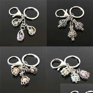 Porte-clés Lanyards Euroamerican Paw Print Pearl Cage Porte-clés Peut Ouvrir Creux Noctilucent Pierre Volcanique Pendentif 2 T2 Drop Deliver Otqzy