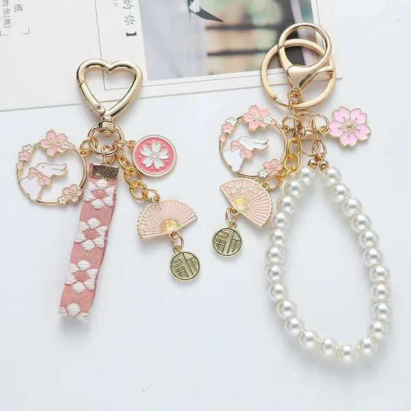 Keychains Lonyards coréens Sweet Cherry Blossom Rabbit Keychain Womens Creative Ribbon Pearl Keynchain Handchain Box Box Pendant Jewelry J240509