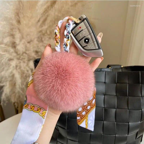 Porte-clés de luxe moelleux véritable boule de fourrure pompon soyeux nœud papillon véritable porte-clés en métal anneau pendentif sac charme pour les femmes X234