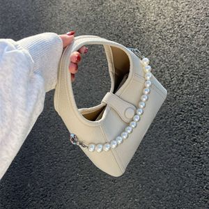 Version coréenne Sac à main de niche pour femmes 2023 Nouveau sac à chaîne de perles, sac à bandoulière à bandoulière unique à la mode et haut de gamme 75% de ventes directes d'usine