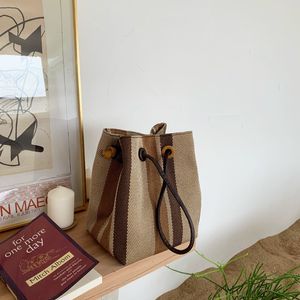 Koreaanse versie van de kleine ontwerpemmer contrasttassen verticaal gestreept geweven canvas handtas