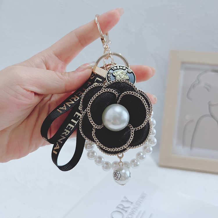 Korean version pearl string mountain camellia key rings fashionable personality bag pendant lady car key chain pendant