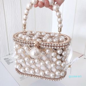 Luxe Pearl Women's Handtas Hollow Out Wedding Clutch Purse Tas Tas Vrouwelijke Strierachtige metalen Cage Basket Schoudertas 3519