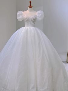 Robe de mariée de robe de bal à paillettes blanches de luxe avec perles perles 2024 manches bouffantes courts arc du dos long étincelle princesse robes nuptiales plies
