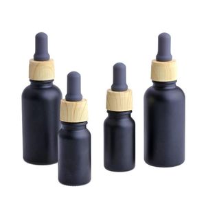 Bouteille de parfum d'huile essentielle liquide en verre noir mat e avec compte-gouttes de pipette de réactif et bouchon de grain de bois 10 / 30ml Uisco