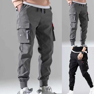 Pantalones para hombres Múltiples bolsillos Cintura elástica y cordón Color sólido Hombres delgados Hombres Beam Pies Pantalones de carga Hombres Pantalones guapos 2021 Y0811