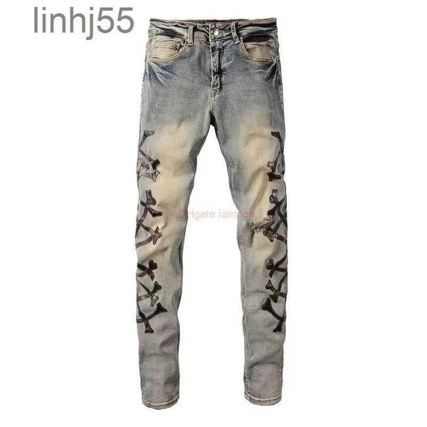 Jeans para hombres Ropa de diseñador Pantalones de mezclilla Amires Amies High Street Camuflaje Hueso con cuchillo de cuero Agujeros cortados Lavado en viejo Me5RV1