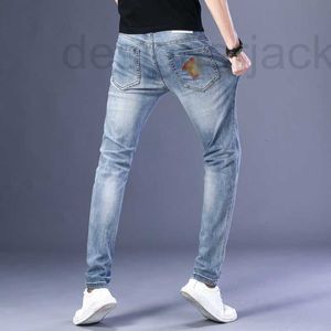 Jeans pour hommes Designer européen printemps / été nouveau mince stretch bleu clair pulvérisation complète multi-processus KHFI