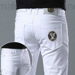 Designer de jeans masculin printemps / été nouveau pour l'édition coréenne de luxe léger et les pieds élastiques minces slim fit coton blanc pant européen long pantalon 3d41 u97b