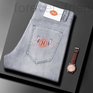 Designer de jeans masculin Spring / été nouveau jeans de nouveau produit, slim ajustement, petits pieds, marque de gamme élastique à la mode haut de gamme pantalon de famille de chevaux imprimé mince élastique mcpx
