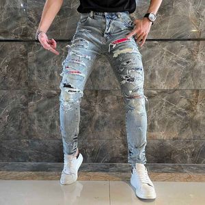 Les trous de chat usés de marque de jeans pour hommes doivent être collés avec un chiffon, gros dégâts, coupe slim, petits pieds, jeans pour hommes micro élastiques, rue haute