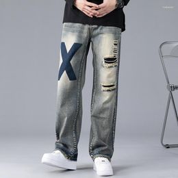 Pantaloni a gamba larga quattro stagioni ricamati stampati stile jeans da uomo con fori Patch alla moda da uomo larghi larghi dritti