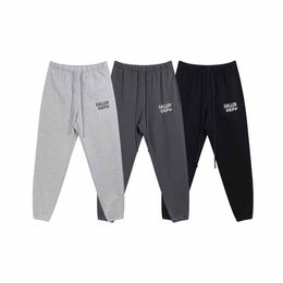 Pantalones de hombre otoño e invierno nuevos pantalones deportivos de lana informales con estampado de letras pantalones deportivos cálidos para hombres y mujeres de la misma moda casual