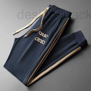 Pantalones de hombre Diseñador Pantalones de chándal para hombre de gama alta pantalones de diseñador otoño con cordones pantalones de protección para los pies hombres mujeres pantalones de jacquard a rayas laterales 0UGW