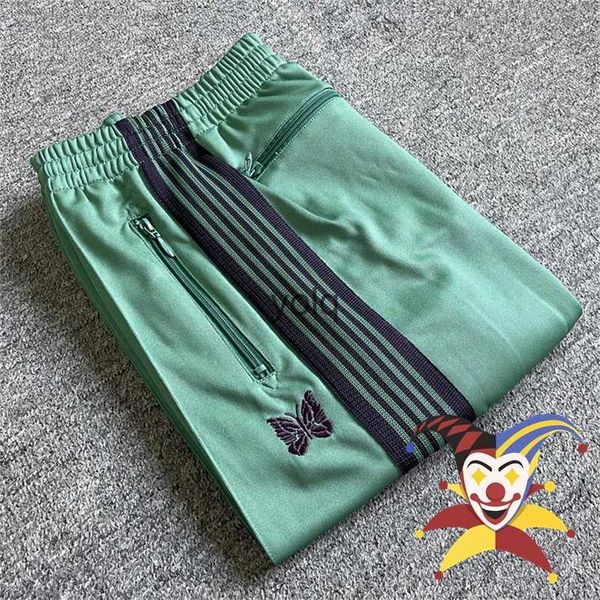 Pantalones para hombres Agujas de rayas púrpuras Pantalones de chándal verdes Hombres Mujeres Bordado Mariposa AWGE Cordón Trackyolq