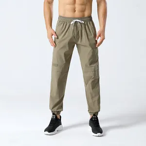 Pantalon masculin Poches de patchwork élastique de printemps solide secoue de pantalon de lanterne sportif à la taille haute