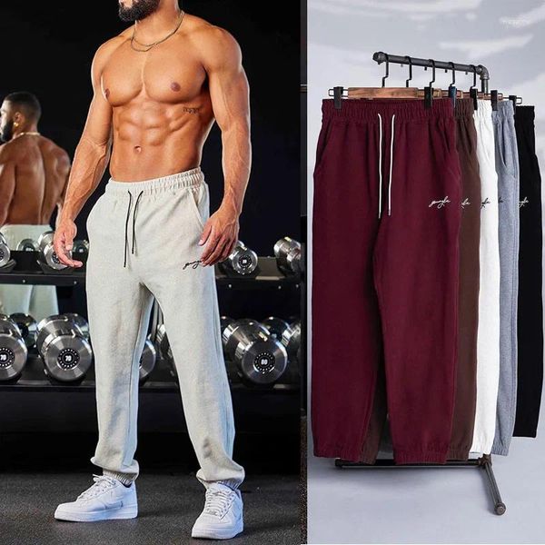 Pantalones masculinos primavera y otoño europeo americano pantalones de marca de moda hombres elásticos deportes de carreras de entrenamiento de fitness trouse