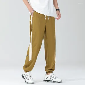 Pantalon pour hommes à rayures à rayures décontractées bandes de la mode boutonnée pantalon boutonné jogging jogging glace pantalon baggy mâle