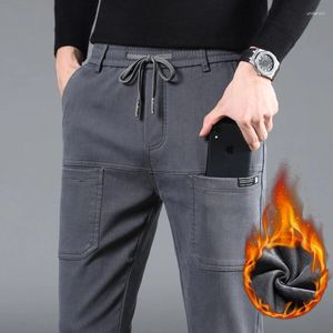 Pantalones para hombres invernal de mosaico casual personalizado de seis bolsillos delgados espesos espesos calientes pantalones de elásticos machos pantalones de elásticos