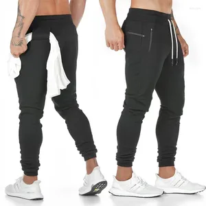 Pantalons pour hommes avec poche Leggings pour hommes Collants de support d'entraînement Serviette en coton Pantalon de survêtement cellulaire Téléphone en cours d'exécution et sport