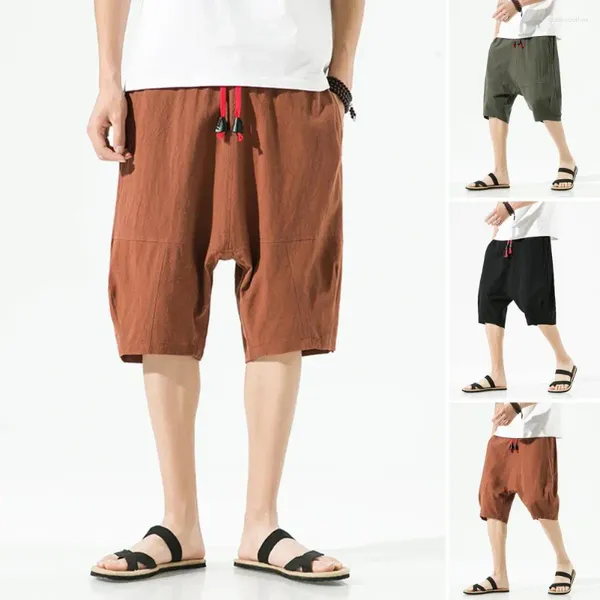 Pantalones cortos para hombres Cintura elástica Cordón Bolsillos de pierna ancha Hombres Color sólido Ropa de calle suelta de playa