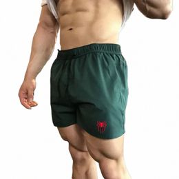 Pantalones cortos deportivos para hombres Gimnasio Diseñador de lujo Pantalones de chándal transpirables Jorts Comentarios coreanos Muchos corriendo Cordón Pantalones de tres cuartos R6iF #