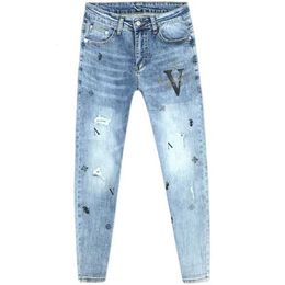 Jeans para hombre diseñador Hot Diamond Print Broken Hole Net Red Slim Fit Pies Moda coreana Marca Azul Nueve puntos Otoño Nuevo
