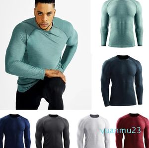 Camiseta para hombre Yoga Europa EE. UU. Ropa deportiva para correr Camiseta de secado rápido Ropa deportiva Entrenamiento de compresión de manga larga Estiramiento Medias delgadas tops