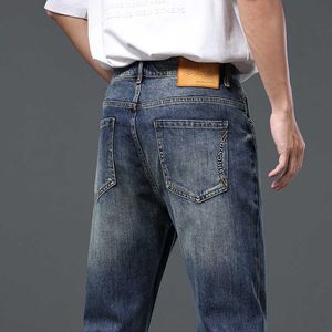 Mens veelzijdige jeans trendy merk elastische slanke fit kleine voeten casual broeken lente en herfststijlen gewassen