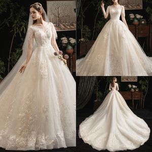 Bescheiden YL Baljurk Jewel Korte Mouw Lace Up Trouwjurken Kant Applique Pearls Beaded Kwastje Bruidsjurken Sweep Train Bridal Towns