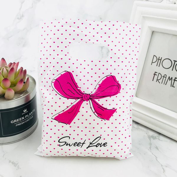 Nuevo diseño 15x20 cm bolsa de plástico de joyería con lazo de lunares rosa fuerte con asas 100 piezas bolsa de compras embalaje decoración de boda