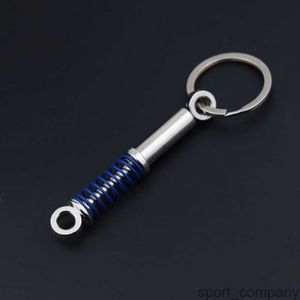 Nieuwe modeauto -schokdemper Keychain voor autoliefhebbers Creatieve Unisex Car Bag Metal Lente Keyrings hangschade geschenken