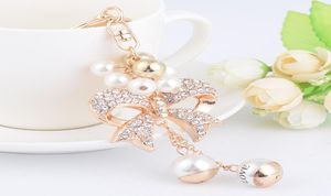 Nouvelle mode ins designer de luxe diamant strass mignon arc perle sac charmes gland porte-clés blanc gold6444195