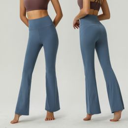 Nouveau pantalon de yoga taille haute pour femmes couleur unie sport nude taille en plastique pantalon évasé serré Fitness lâche jogging vêtements de sport pantalon évasé à neuf points de haute qualité