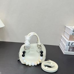 Nuevos modelos Handheld Shell Bag Designer Luxury Pearl Crossbody Bag Cowhide Women's Retro Fashion Mochila logotipo de Diamante Gran Diamante Bolsa Bolsa Cosmética